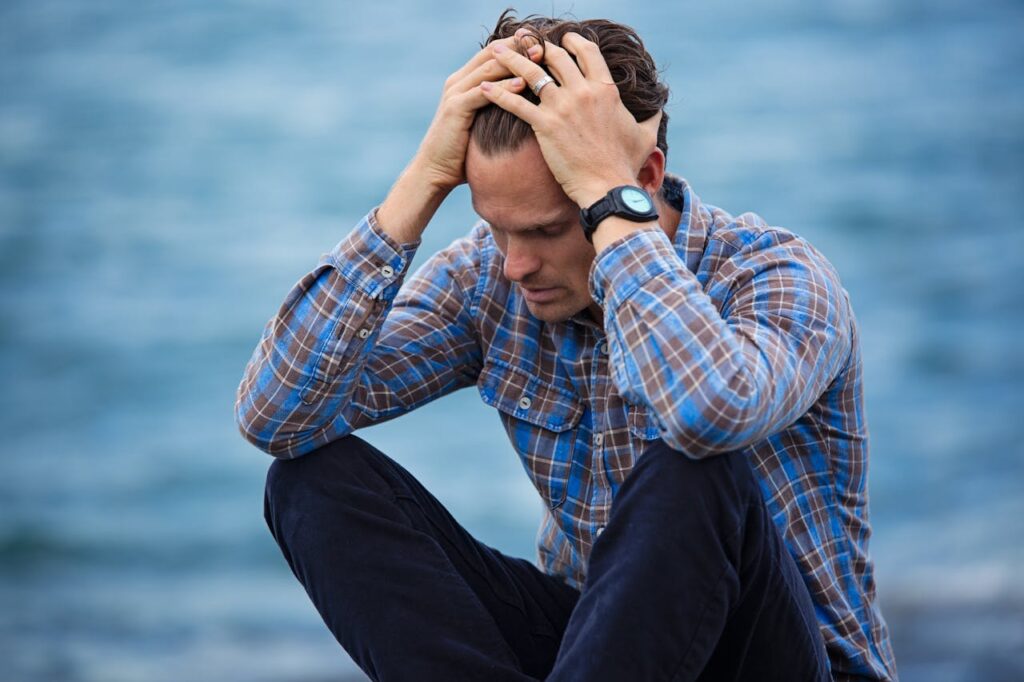 photo of a frustrated man, one of 10 Life-Changing Hacks to Escape Being Broke